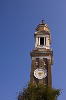 Clock tower at Santi Apostoli church in Venice Italy