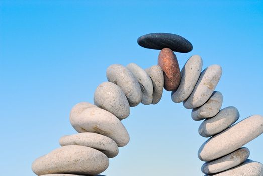 White sea pebble combined in an arch with a black stone with top