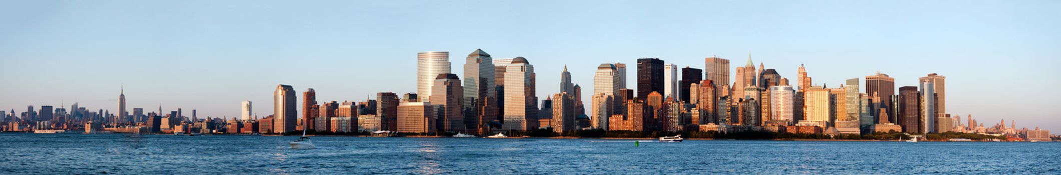 Panorama of New York City Manhattan skyline showing downtown financial district with world trade center WTC and midtown with Empire State building.