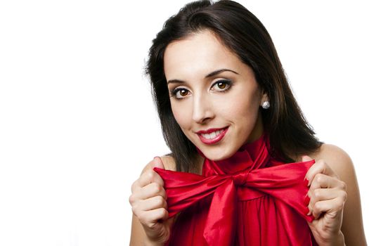 Face of a beautiful happy Caucasian Hispanic woman with red lipstick stretching satin bow-tie shirt, isolated.