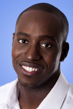 Happy smiling face of a handsome African American business man wearing a white shirt, isolated.