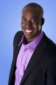 Handsome happy African American corporate business man smiling, wearing black suit with purple shirt,  isolated.