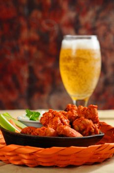 Buffalo style chicken wings served with cold beer.