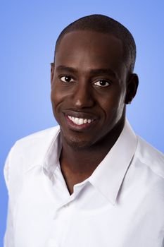 Happy smiling face of a handsome African American business man wearing a white shirt, isolated.