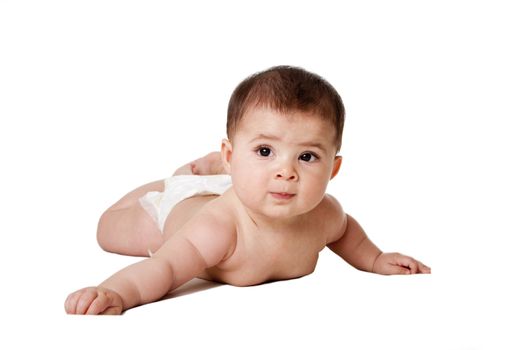 Beautiful cute happy Caucasian Hispanic baby infant laying on belly, wearing diaper, isolated.