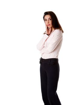 Beautiful serious worried successful Caucasian Hispanic entrepreneur business woman standing, wearing dark blue pants and pink shirt and arms crossed, isolated.