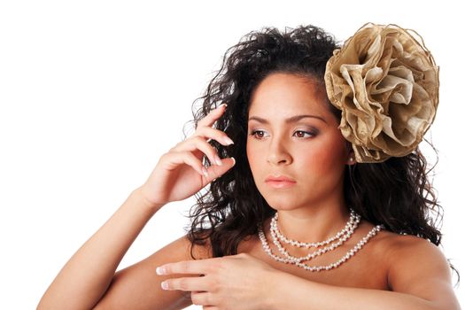 Beautiful face of a Caucasian Hispanic fashion model woman with clear skin, wearing a pearl necklace and a fake flower in curly hair, isolated.