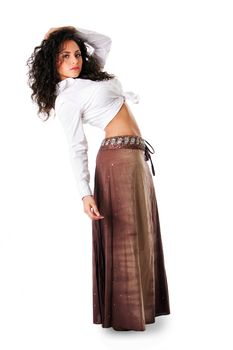 Sexy beautiful Caucasian Hispanic Latina young woman with brown curley hair leaning backwards. Cute tanned brunette, ethnic girl in white knotted shirt and brown skirt standing showing belly, isolated.