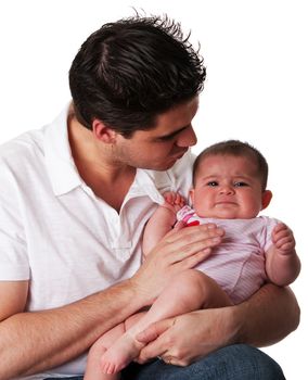 Handsome Caucasian Hispanic father trying to calm his cute unhappy crying baby daughter, isolated.