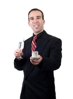 An excited young man showing the ring he is going to propose with, isolated against a white background