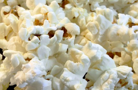 Scattered flakes of salty popcorn. Photo close-up