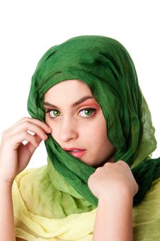 Portrait of shy mysterious beautiful Caucasian Hispanic Latina woman face with green penetrating eyes and green fashion scarf wrapped around head, isolated.