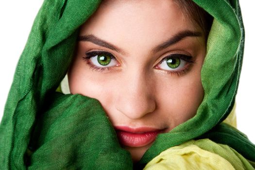 Portrait of mysterious beautiful Caucasian Hispanic Latina woman face with green penetrating eyes and green fashion scarf wrapped around head, isolated.