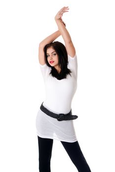 Beautiful fun brunette Caucasian Hispanic Latina woman with red lipstick standing with hands in air, wearing white shirt and black leggings, isolated.
