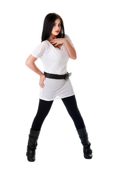 Beautiful brunette Caucasian Hispanic Latina woman with red lipstick standing with legs spread, wearing white shirt, black leggings and belt, isolated.