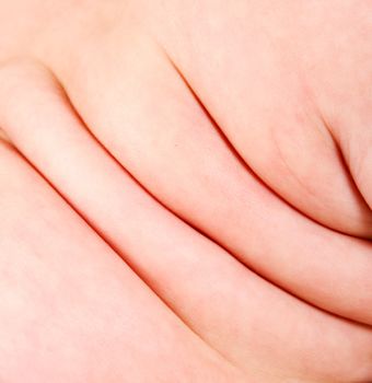 Cute rolls of fat skin on the side of the back of a Caucasian baby.