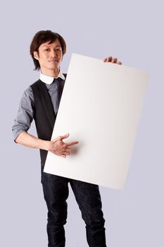 Asian business man holding and presenting a blank white board and pointing at it, isolated.