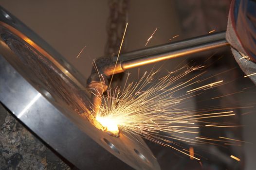 a close picture of a torch cutting steel