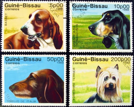 Guine-Bissau postage stamps featuring four different dog breeds.