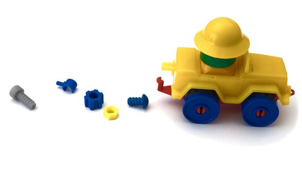 Yellow toy machine on the white background