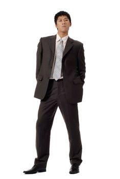Business man of coldness, full length portrait of Asian office worker in formal suit standing and showing unfriendly expression, isolated on white background.