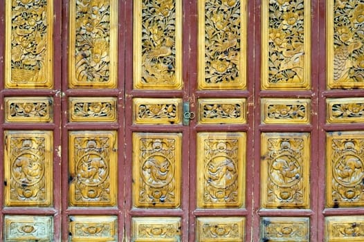 Wooden door in old style, shop entrance. China, Yunnan province, Lijiang - old town. 