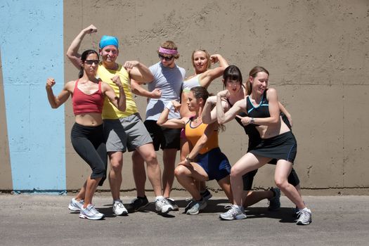 Group of friends have fun posing after a run.