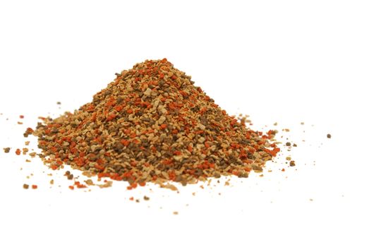 A heaping pile of pet fish food on a white background.