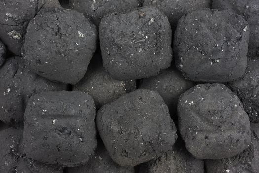 background of small charcoal briquets used in barbecue grill