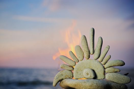 The stone sun burns on a beach in the summer evening