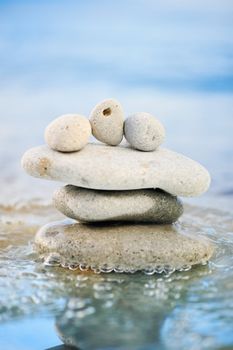 Sea pebble and quiet waves on a summer beach