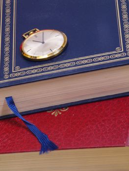 pocket watch over old books