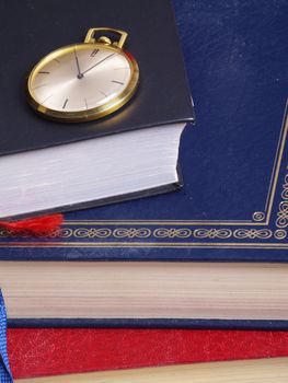 pocket watch over old books