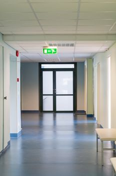 Long corridor in hospital with doors and reflections 