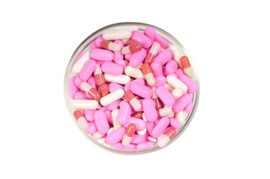Shot of pink drugs (tablets) isolated on white