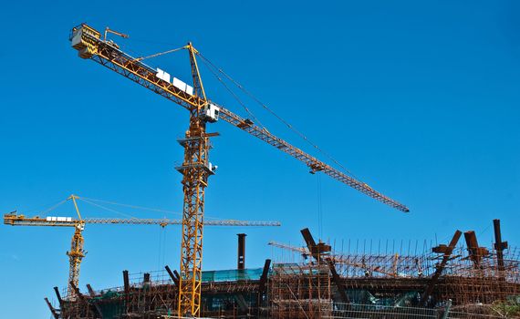 Busy construction site, crane movements