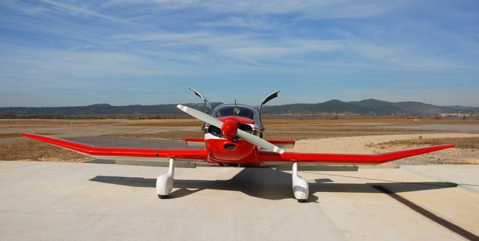 private red plane Robin DR 250 on an airport in the south in France