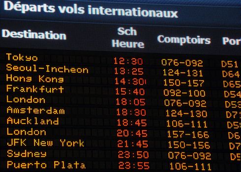 Canadian airport information board, international departures, French.