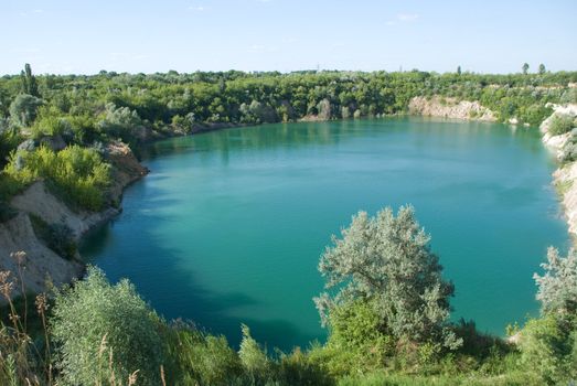 a very large deep rock quarry filled with water