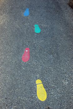 painted footprints on tarmac in infant school playground