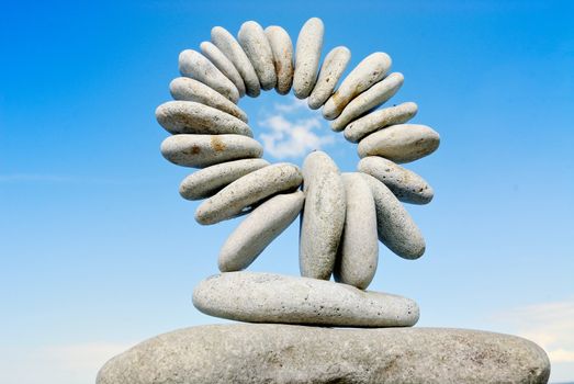 Sea pebble combined in the form of a circle against the sky