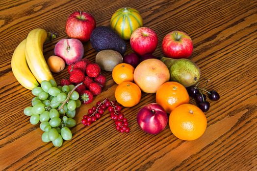 Selection of colorful, fresh, natural looking fruit on wooden background.