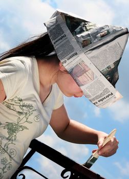 Youn girl with paper hat is painting balcony rail in a suuny but cloudy day