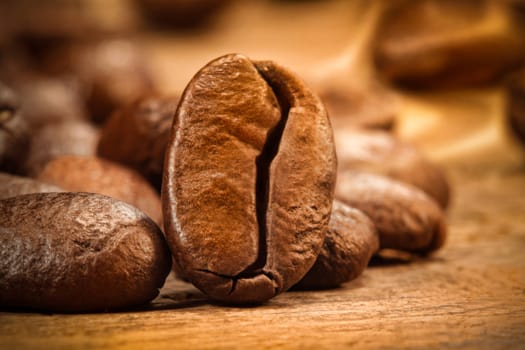 Closeup shot of a coffee bean on wood