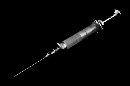 Reusable syringe on a black background on the diagonal