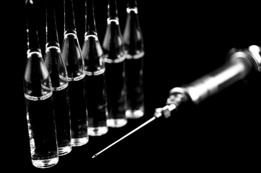 Reusable syringe and ampoules on a black background 