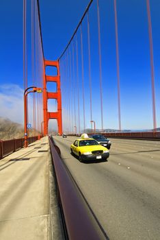Yellow taxi crossing the Golden Gate Bridge in San Francisco, California, USA
