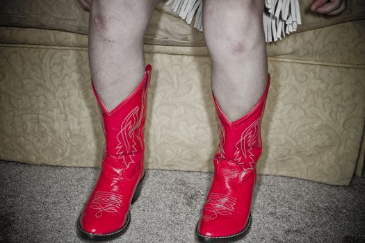 Young girl dressed up in cowgirl outfit.