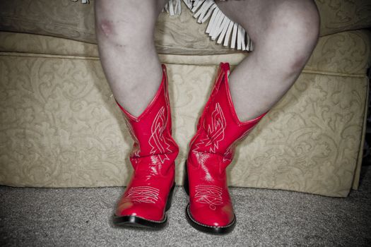 Young girl dressed up in cowgirl outfit.