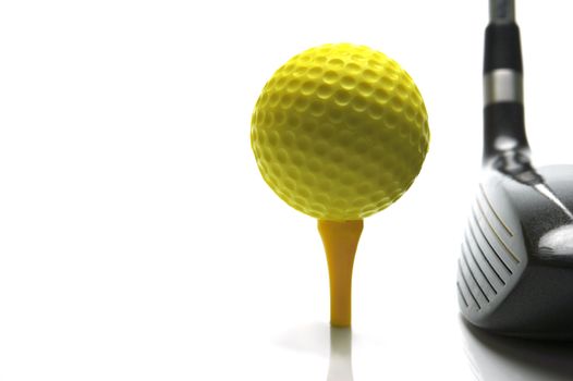 Golf ball and a golf club isolated against a white background